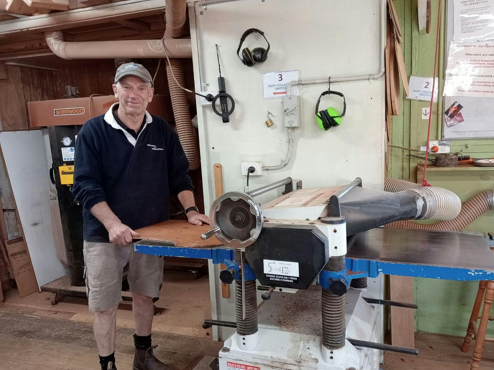 Guild member using the thicknesser