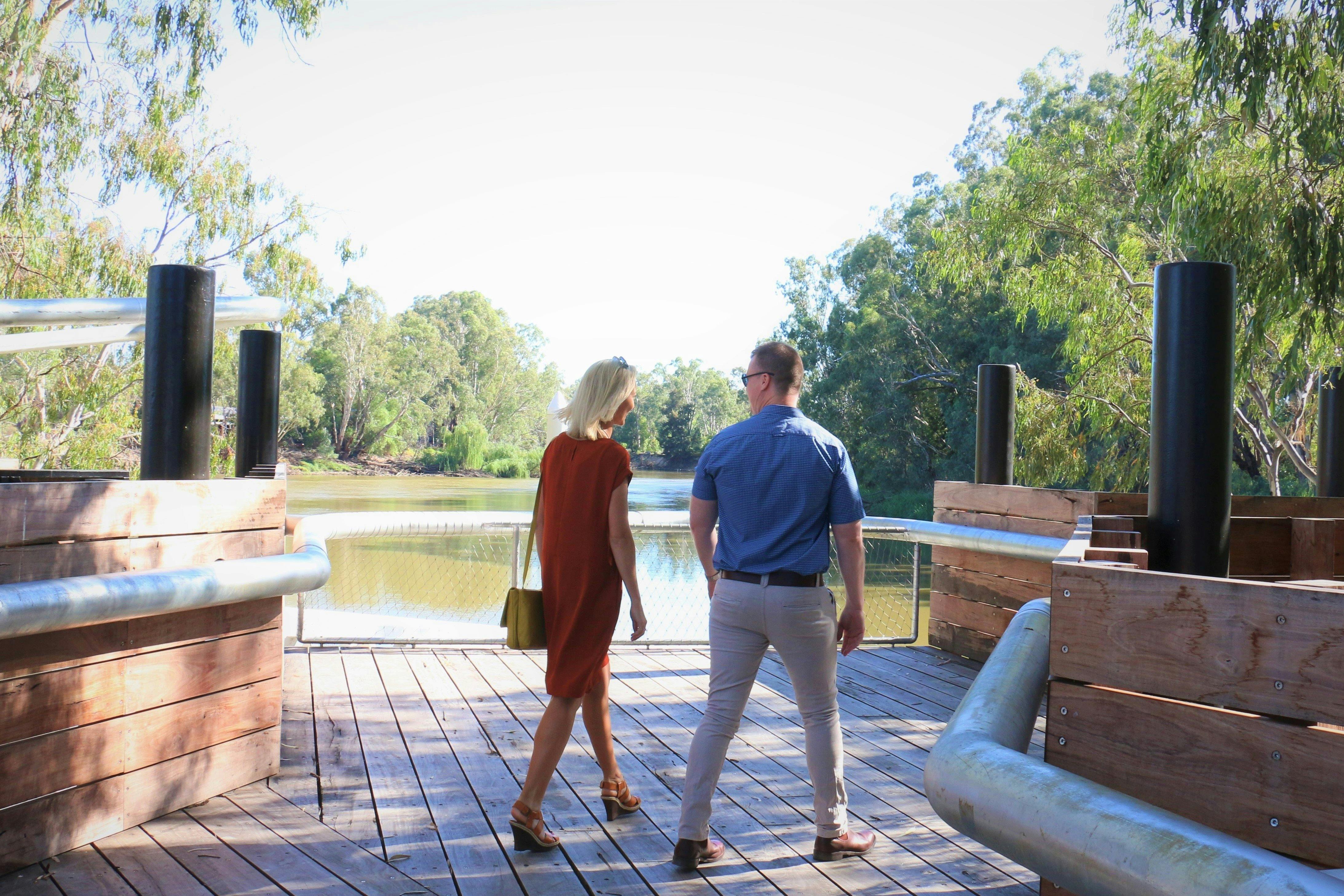 Young couple walking on Koondrook Wharf on the Murray River
