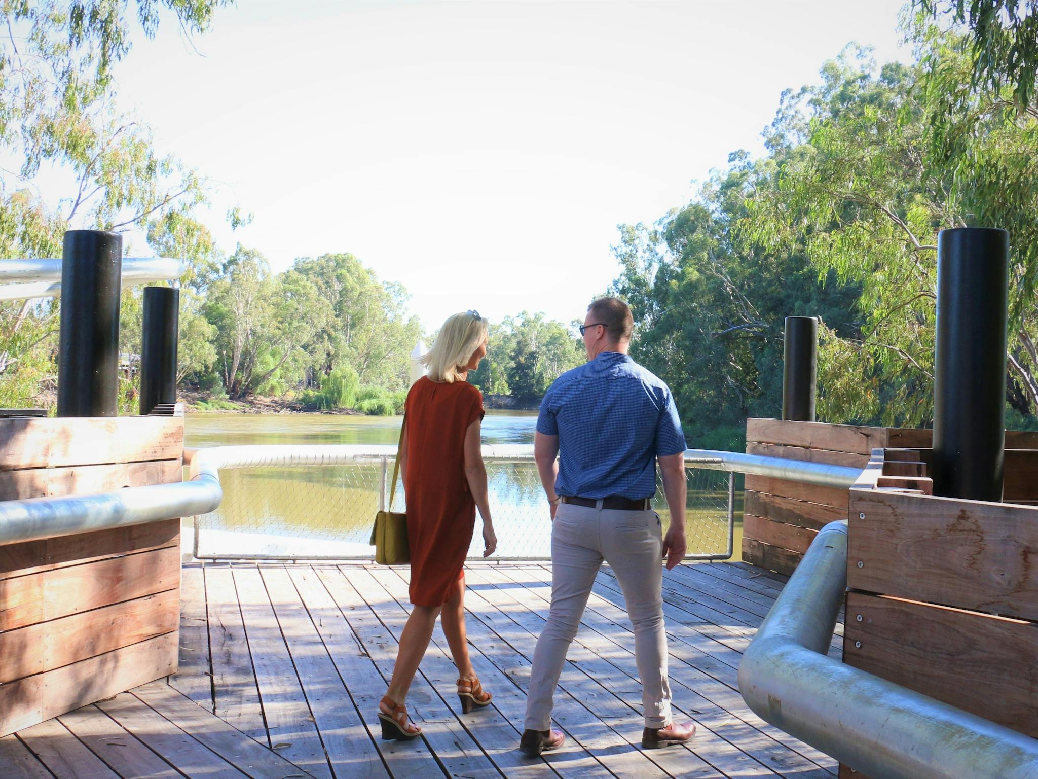 Young couple walking on Koondrook Wharf on the Murray River