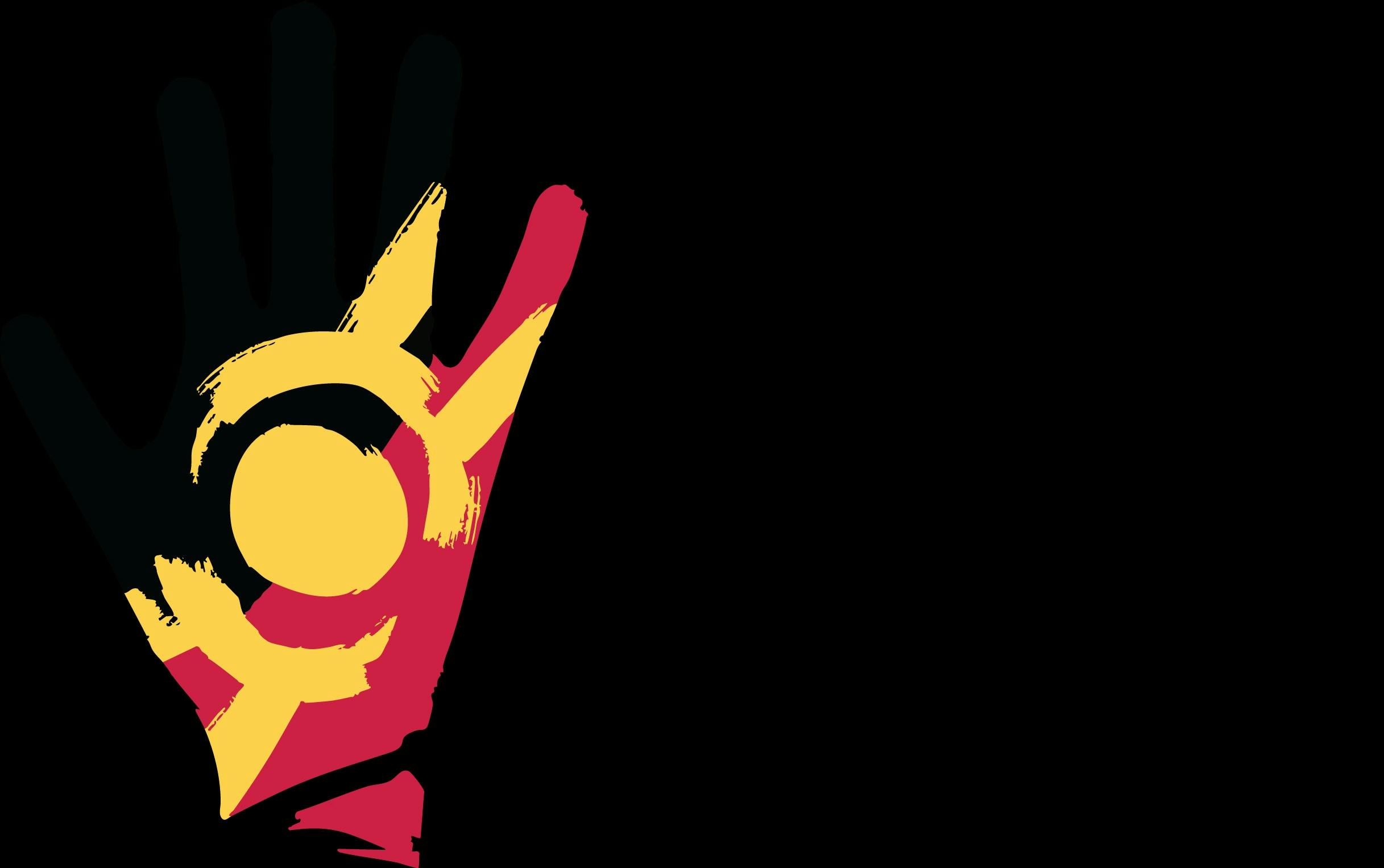 A hand in Aboriginal flag colours