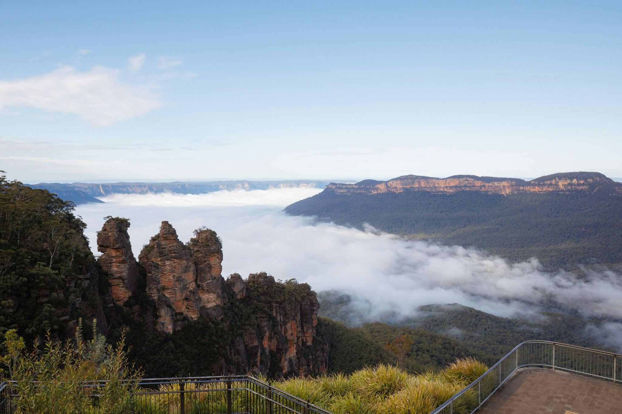 An image of the famous Echo Point lookout and Three Sisters with mist settled in the valley.