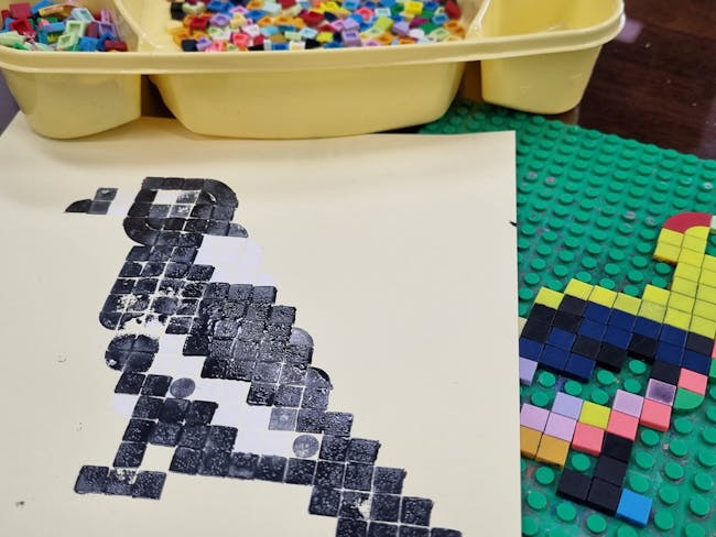 relief print of a magpie using Lego dots