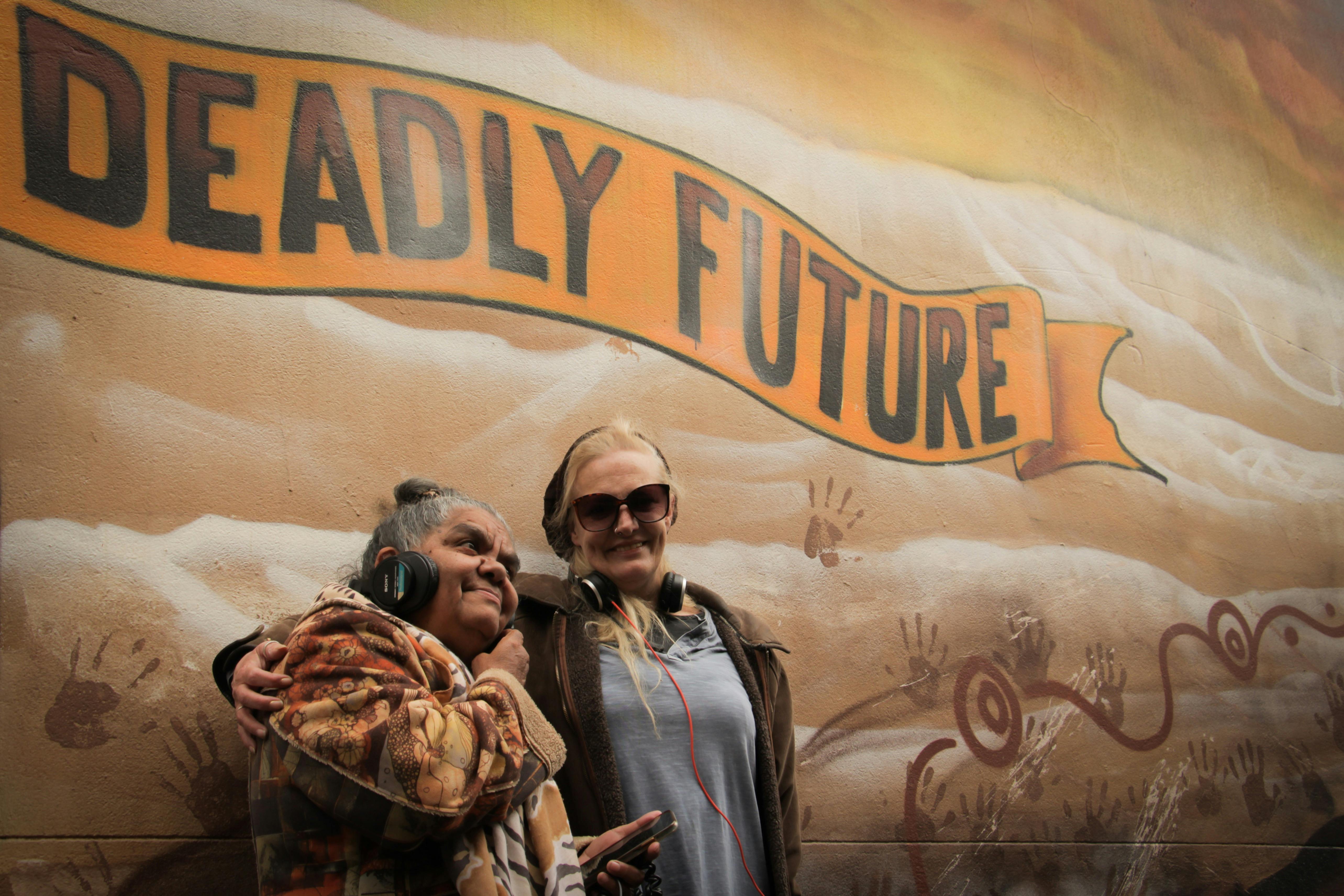 Aunty Rieo Ellis and Charley Woolmore listening to the Yalinguth app at the old Health Service