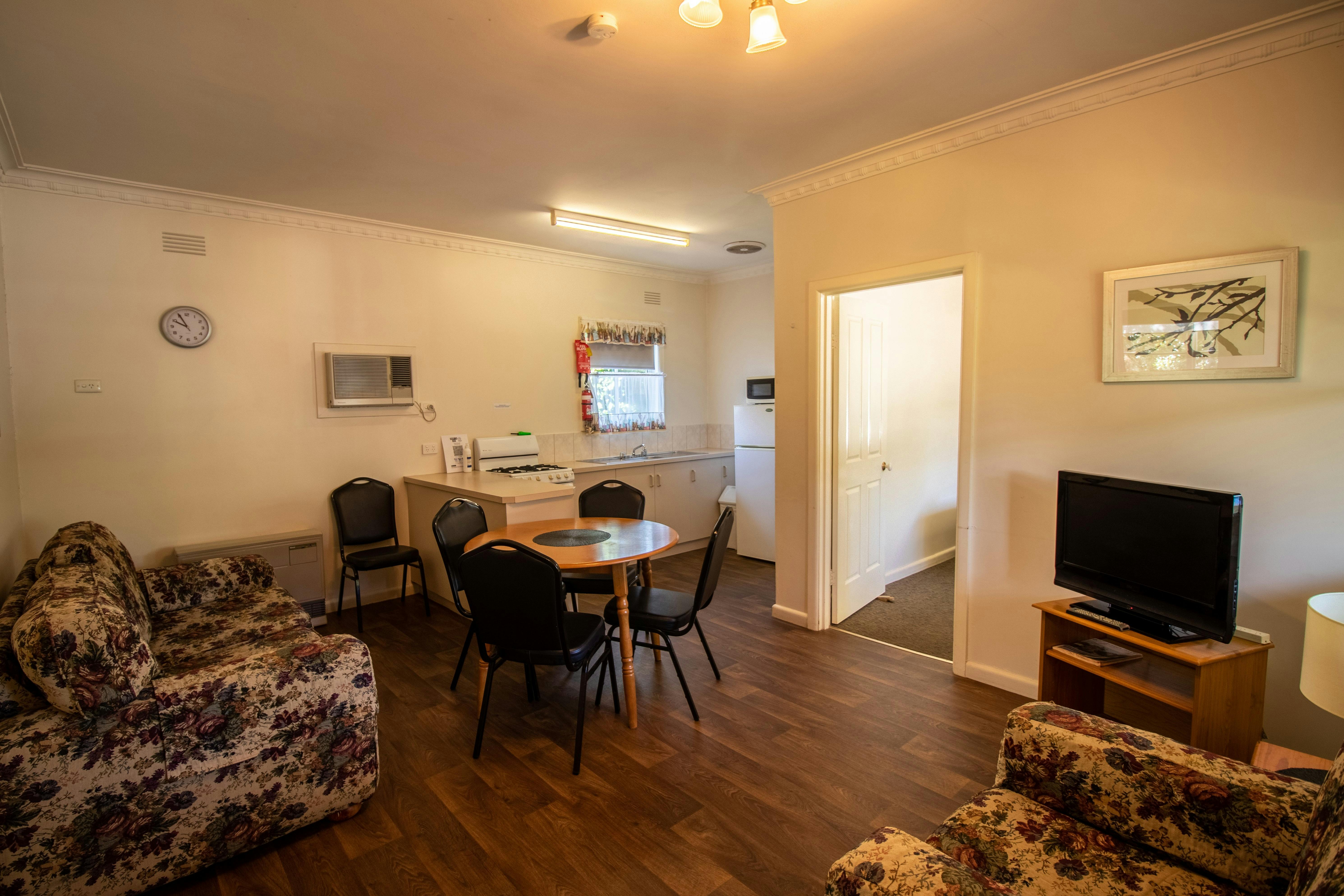 Unit 1 Living Room, TV, Kitchenette, Dining Table & Seats