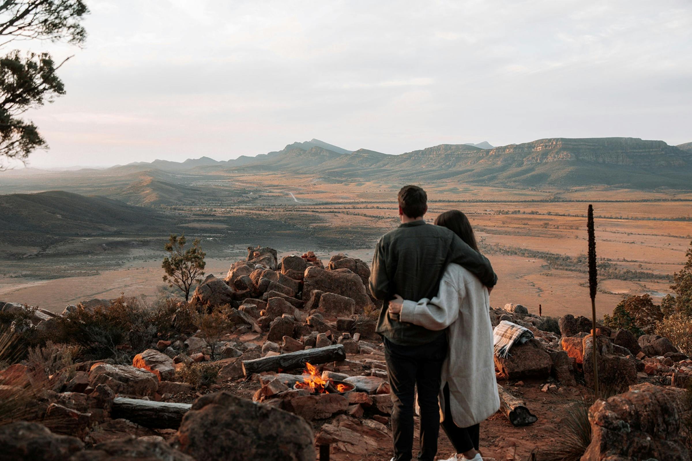 Couple on Chace Range enjoying a open fire as part of their heli-camping experience