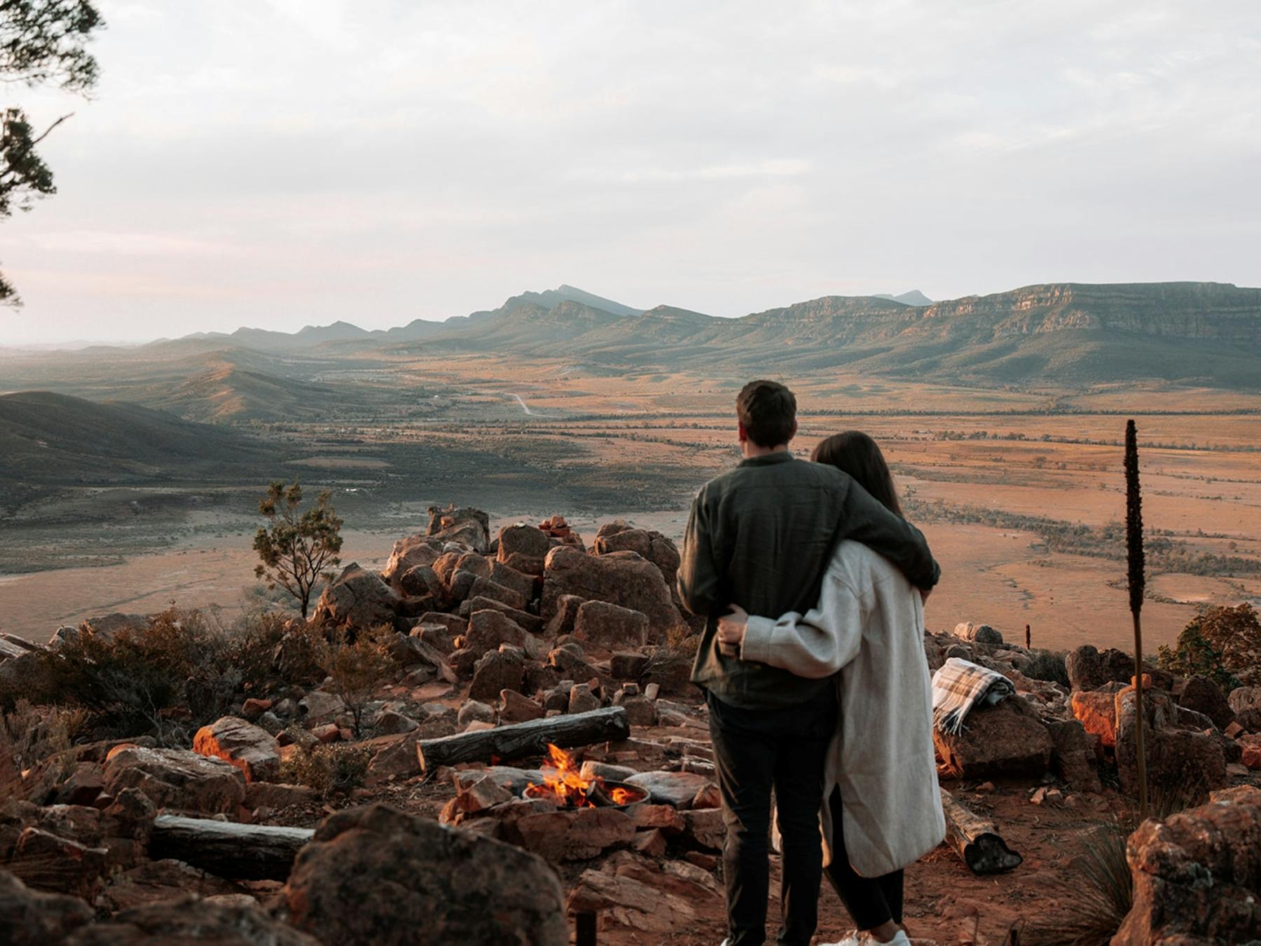Couple on Chace Range enjoying a open fire as part of their heli-camping experience