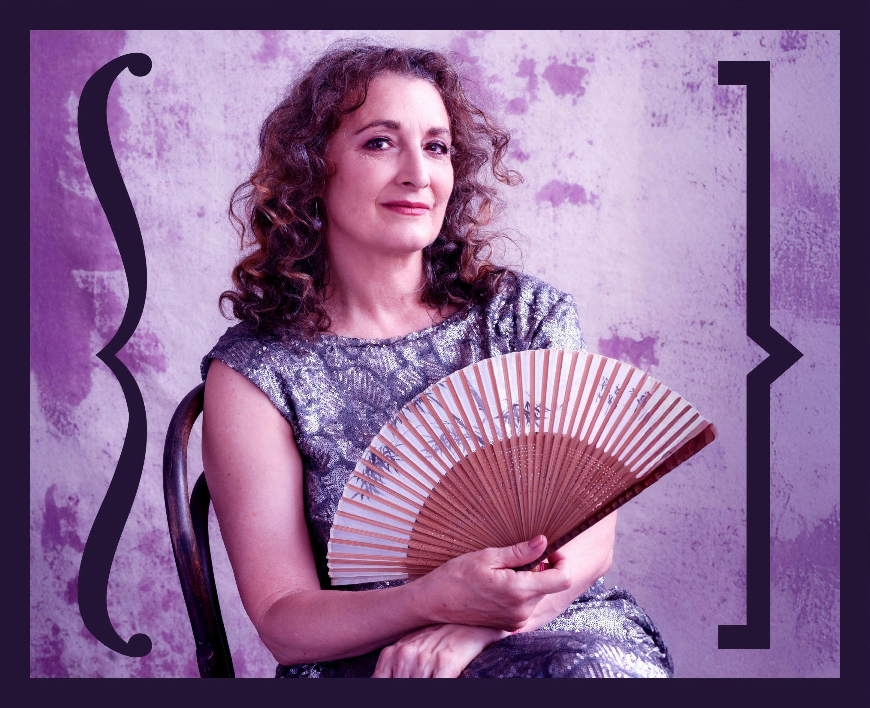 Delia Hannah holding a fan