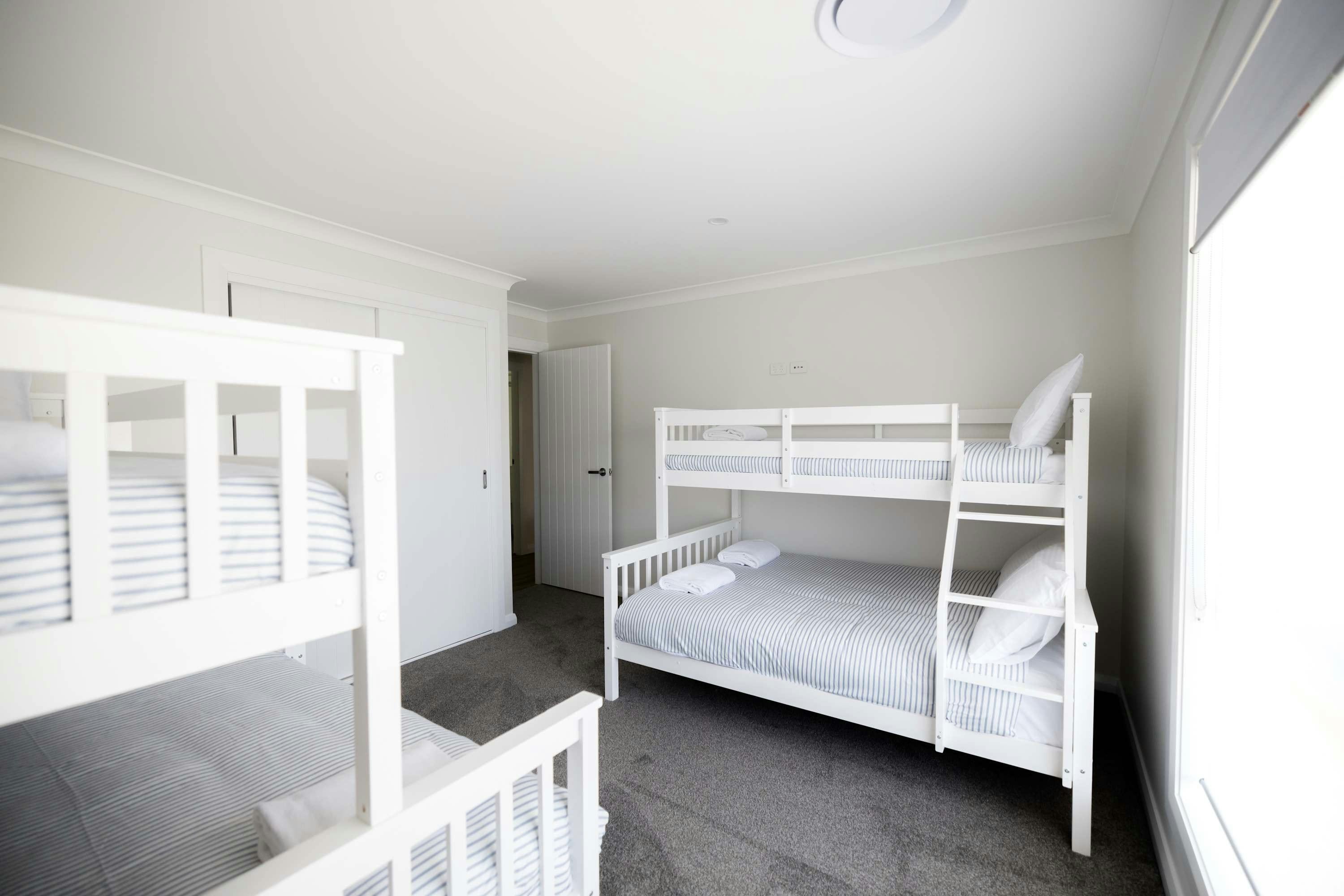 Perfect bedroom for kids with 2 bunk beds, doubles on the bottom and singles on the top.