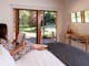 Guest relaxing on bed at Hume House Merrijig