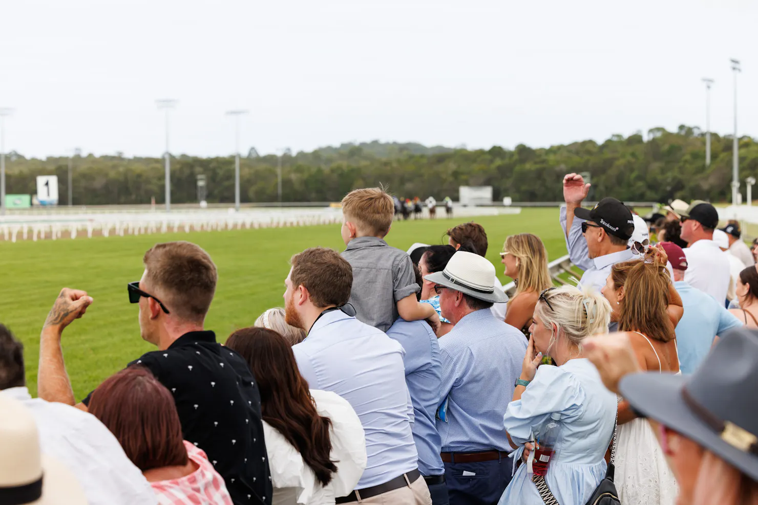 Crowd cheering on the horses