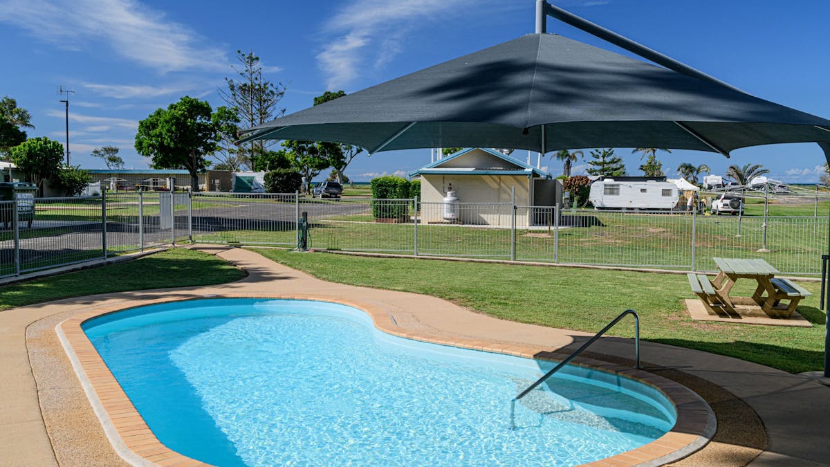 Swimming pool with shade umbrella.