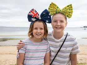 Two kids smiling at the beach
