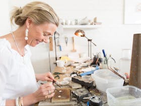 Lucinda at the workbench in the shop