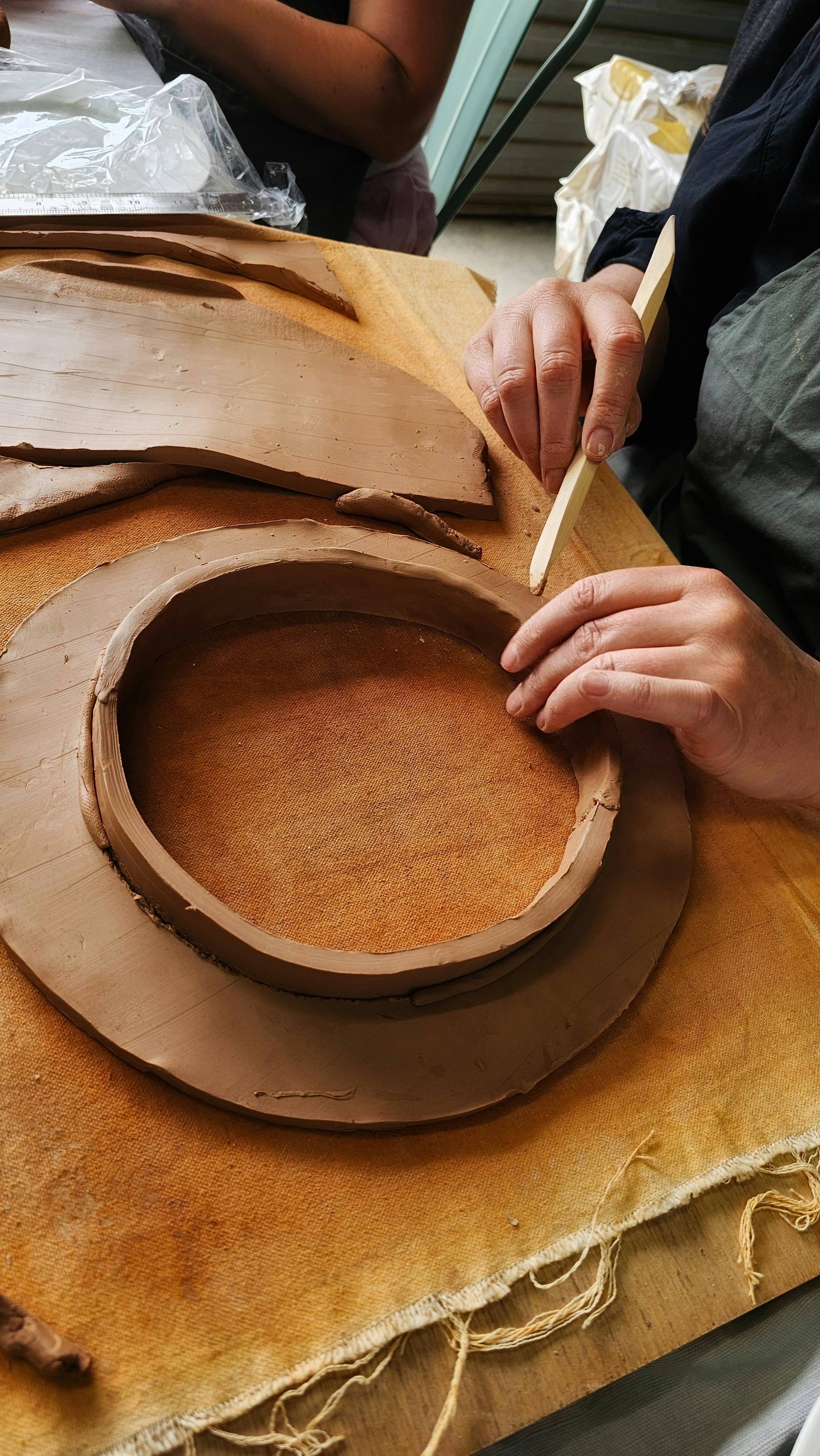 Hands working with clay