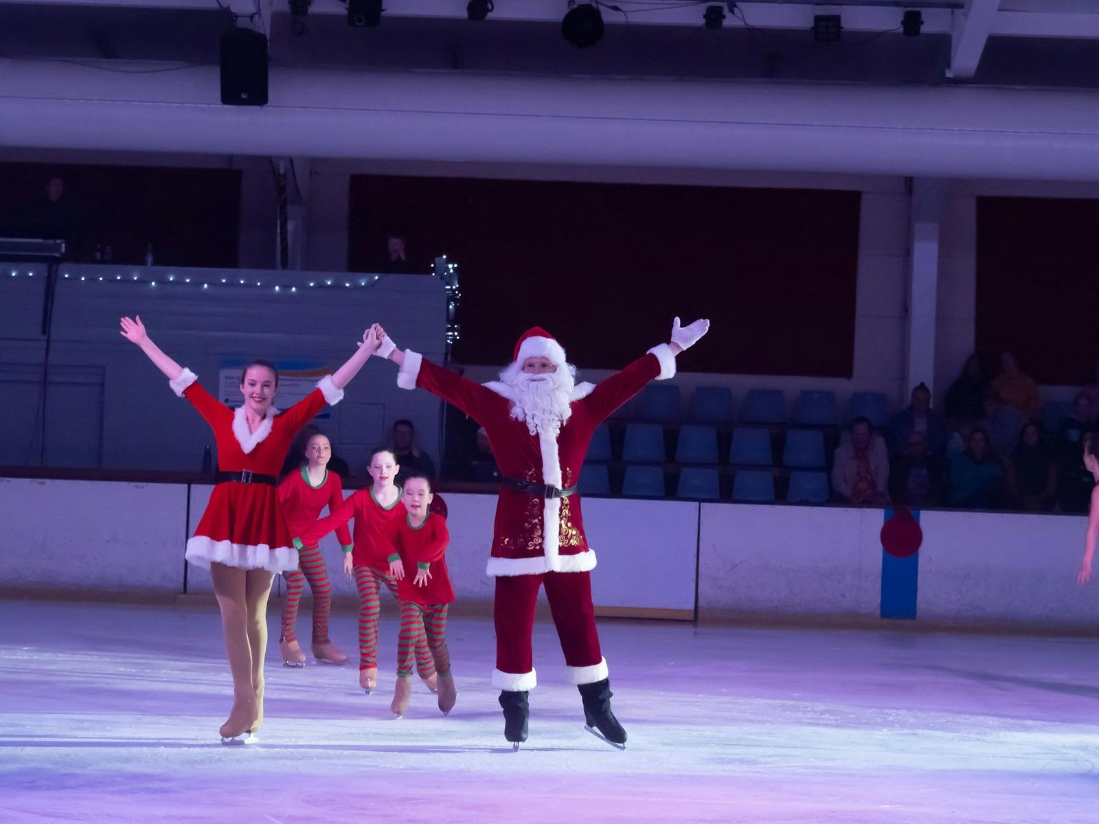 Skaters dressed as Santa and Mrs Claus along with little skaters.
