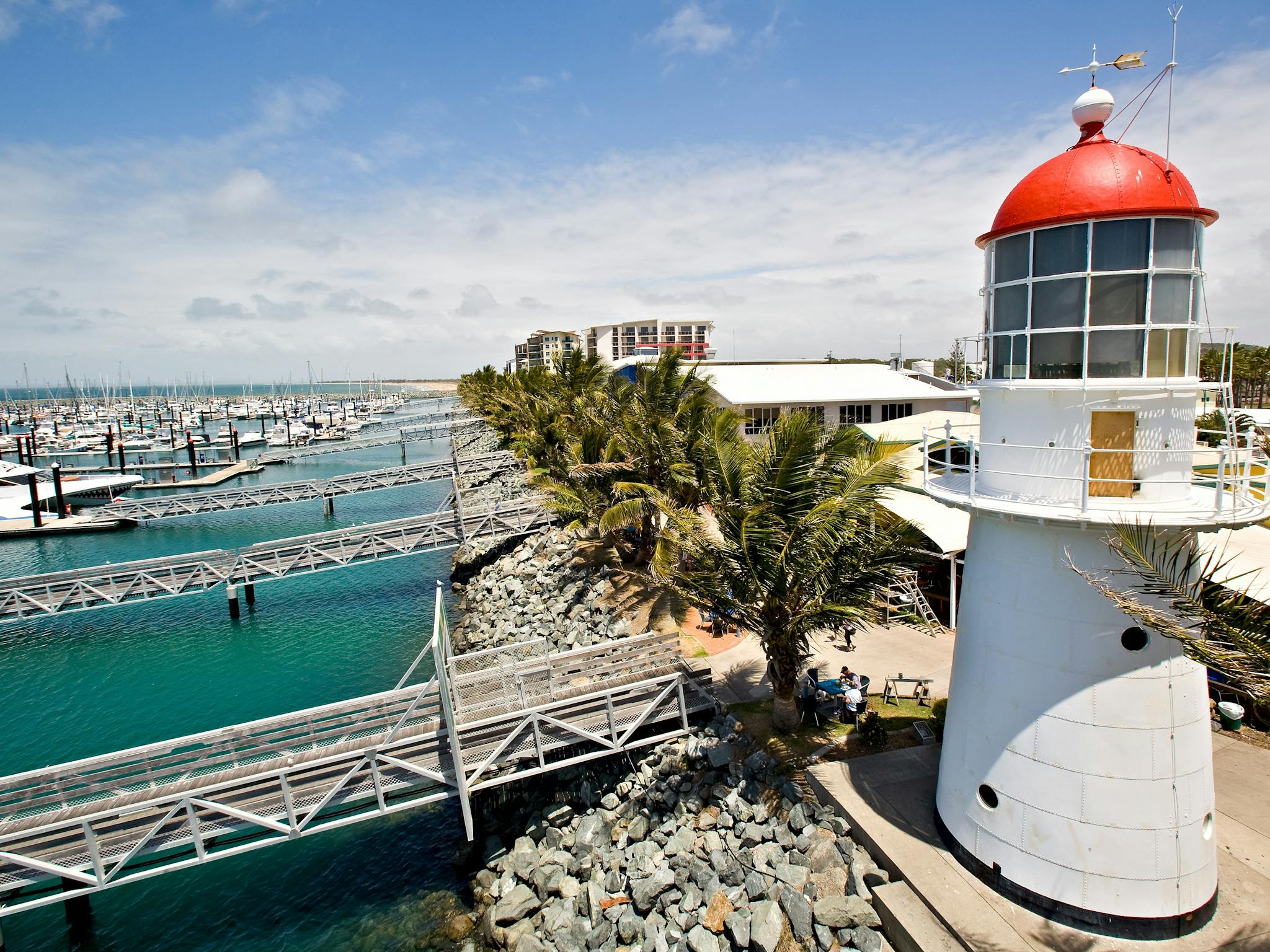 Aerial shot of the Pine Islet lighthouse at the Mackay Marina, boats, jettys, rockwall and water. Aerial shot of the Pine Islet lighthouse at the Mackay Marina, boats, jettys, rockwall and water.