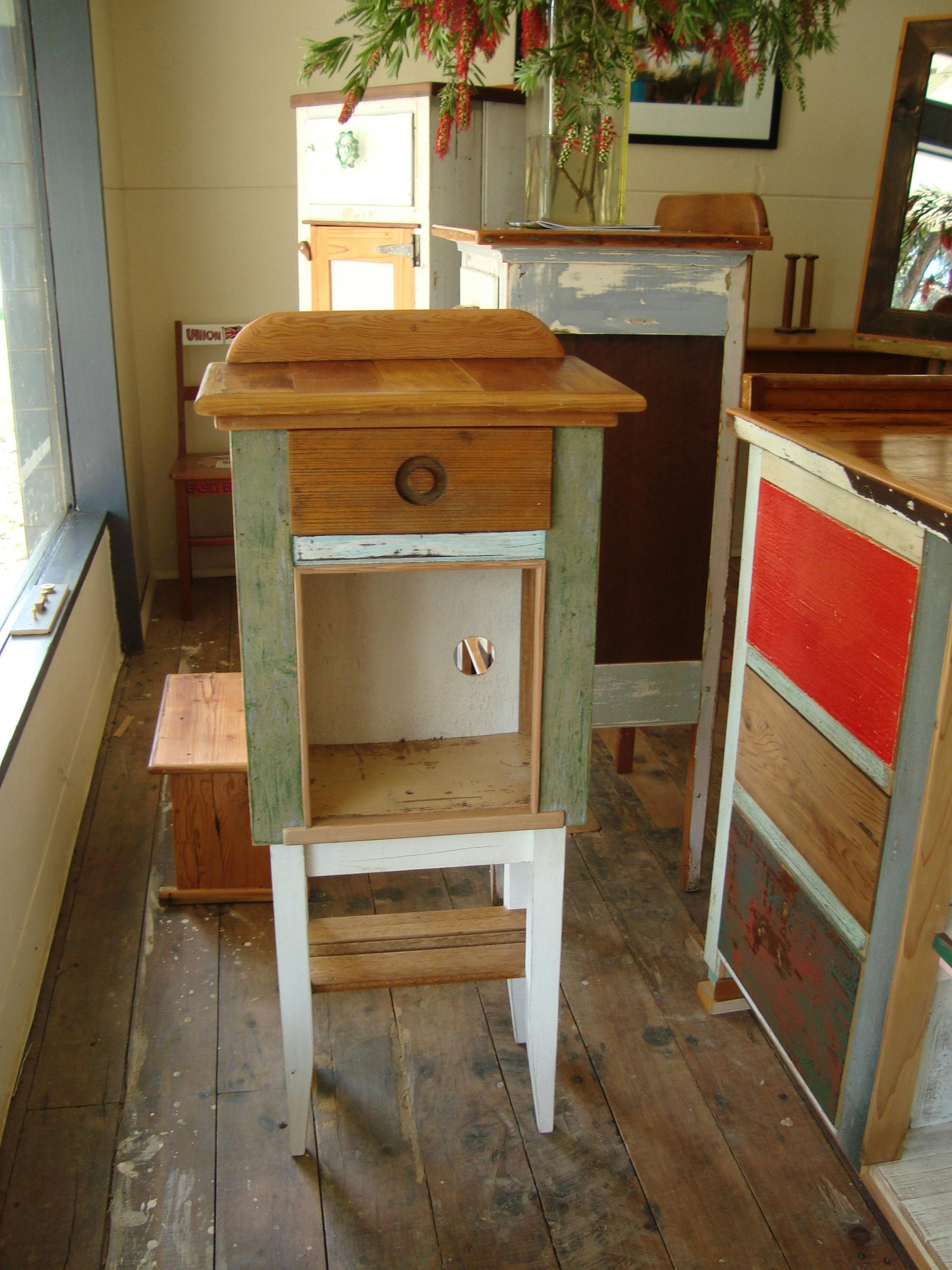 One-door-one-drawer cupboard made from an old bee box, on legs