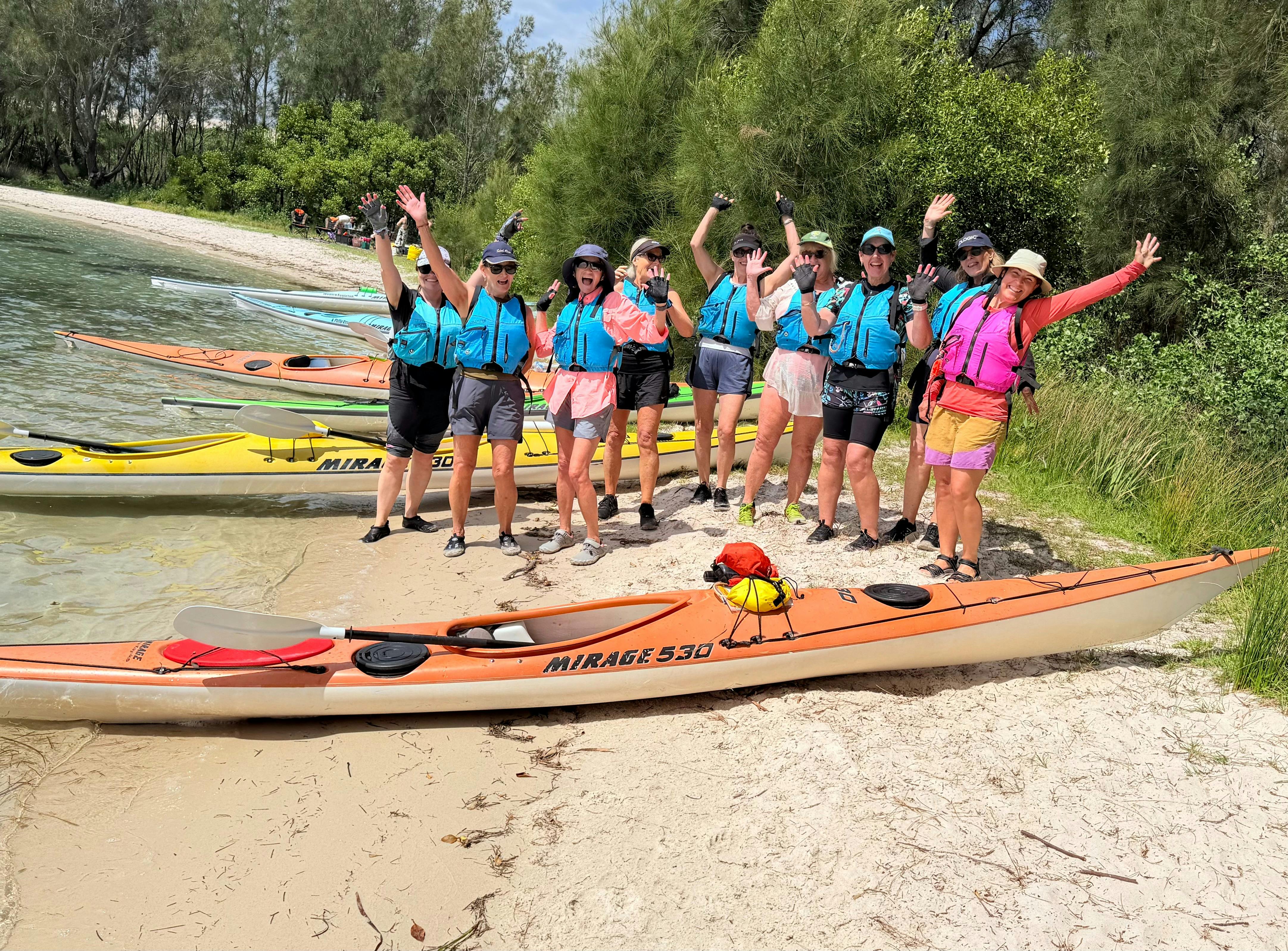 Women on the beach with Kayaks in the forground