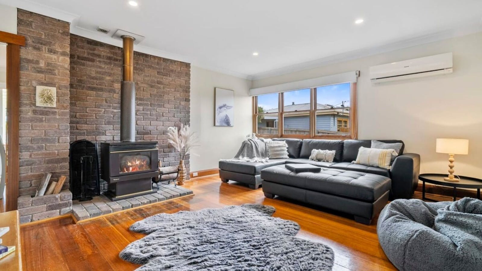 Fire place in a large lounge room with large Television