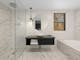 Renovated modern bathroom with large shower and spa bath