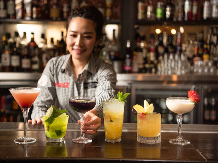 Bar tender serving a range of cocktails