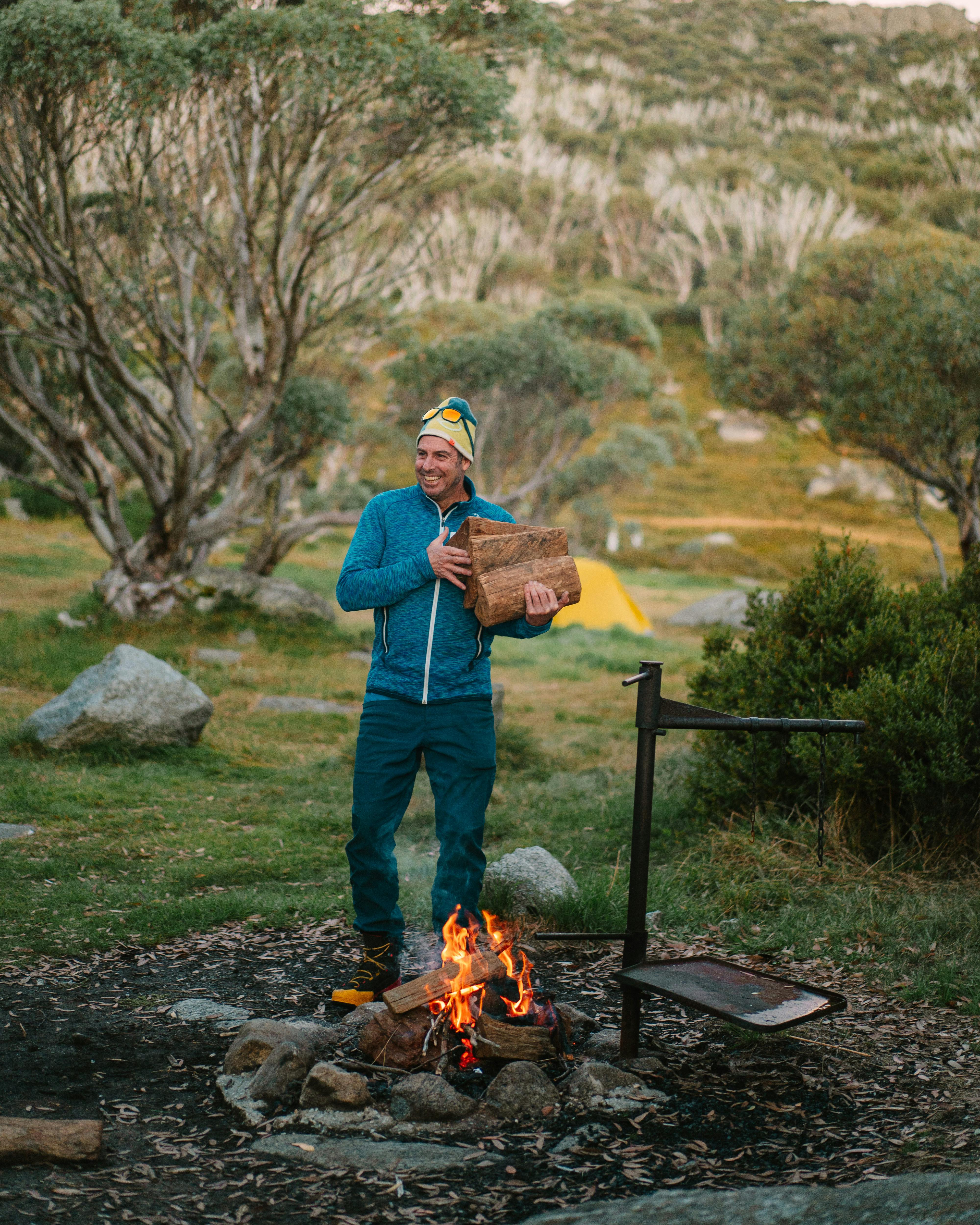 Man standing next to a bonfire