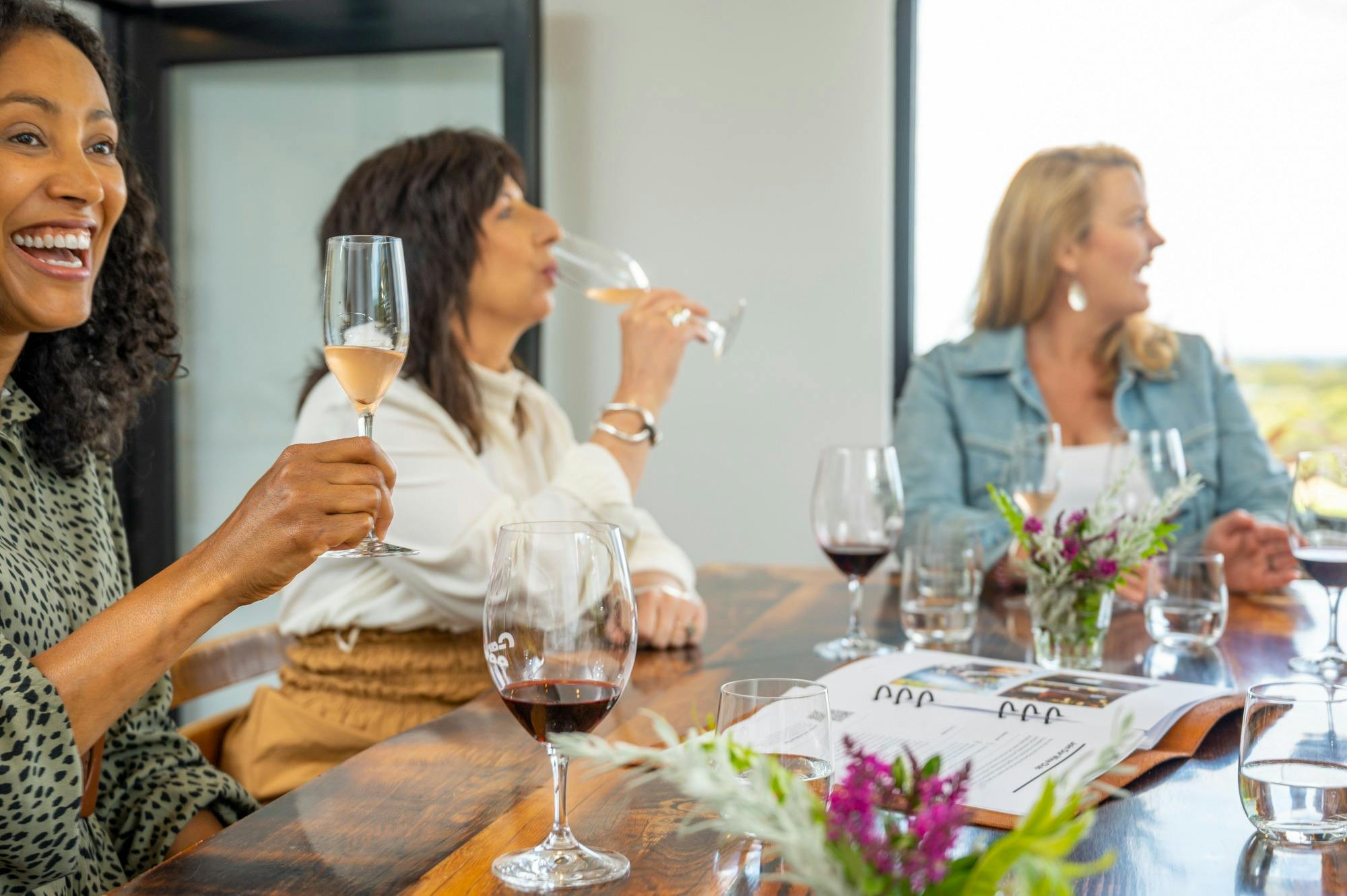 A group of women tasting wine in a cellar door