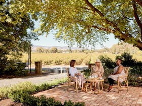 Guests enjoying the front yard of Wilsford House with stunning winery views.
