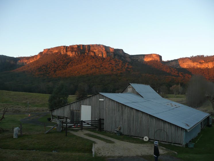 Sunset on cliffs with heritage woolshed