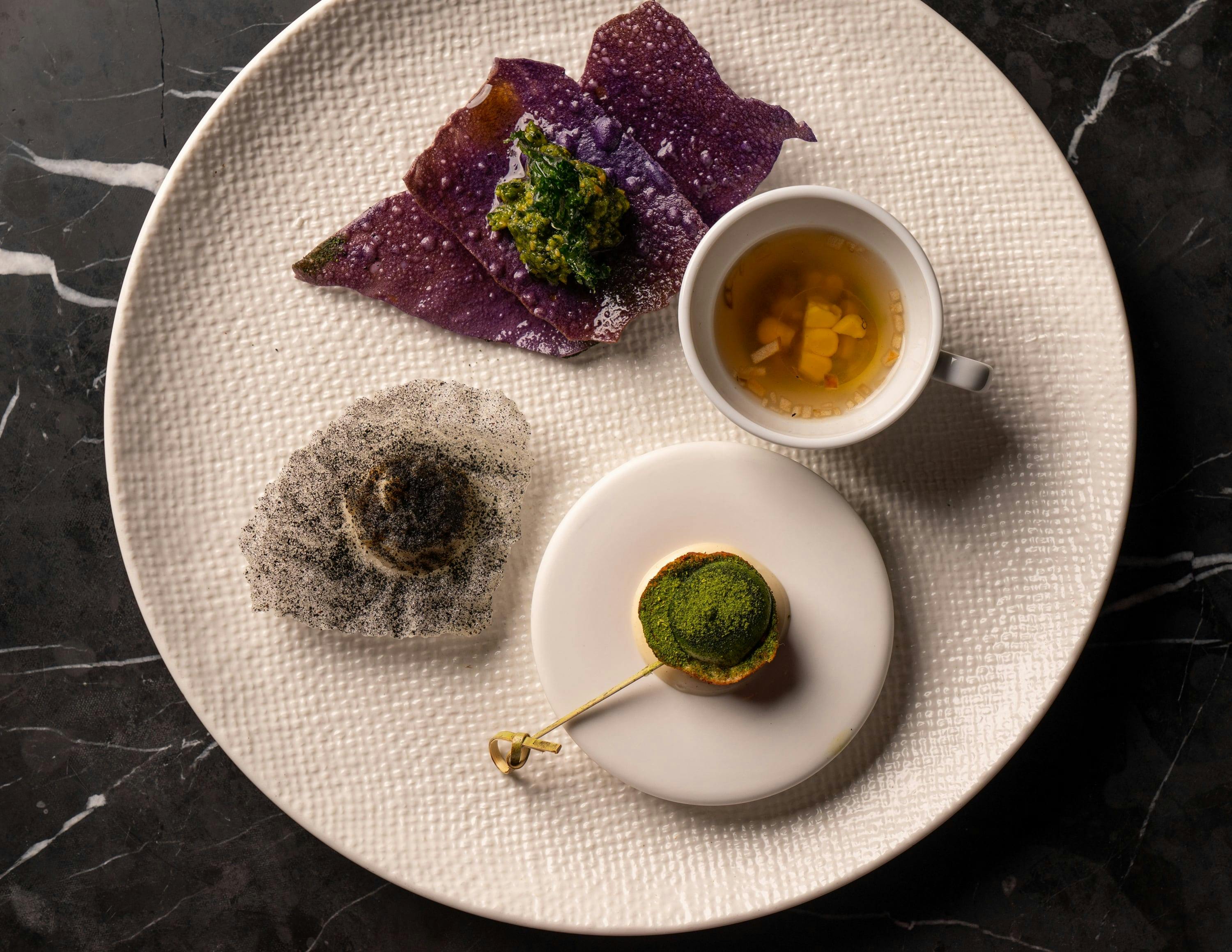 Sweet Corn & Parmesan Consomme, Okinawan Potato Crisp, Pork Ascolana Olive, Barramundi Baccala