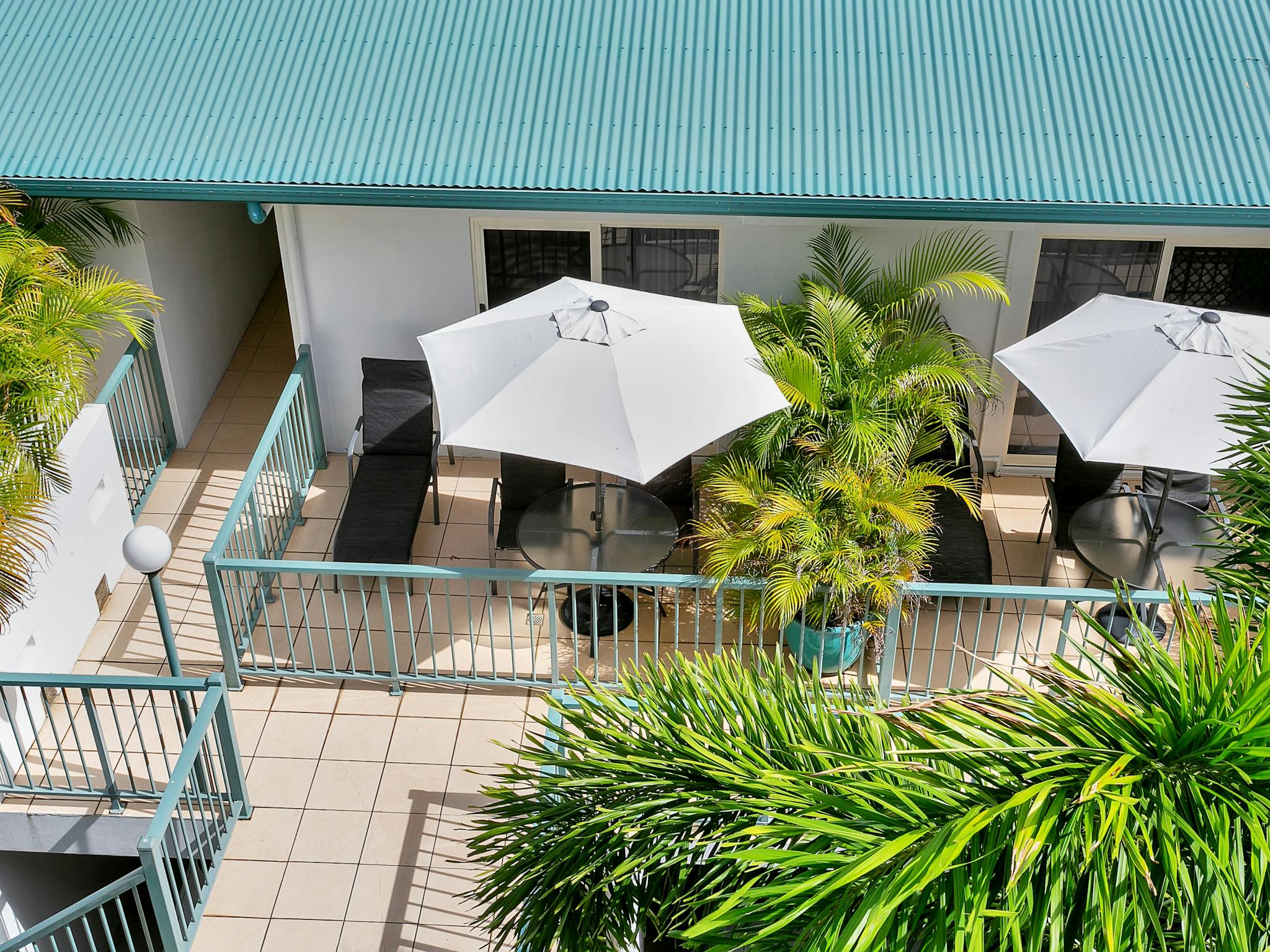 Large private balcony with umbrellas and seating overlooking the gardens. shade and Large private balcony with umbrellas and seating overlooking the gardens. shade and
