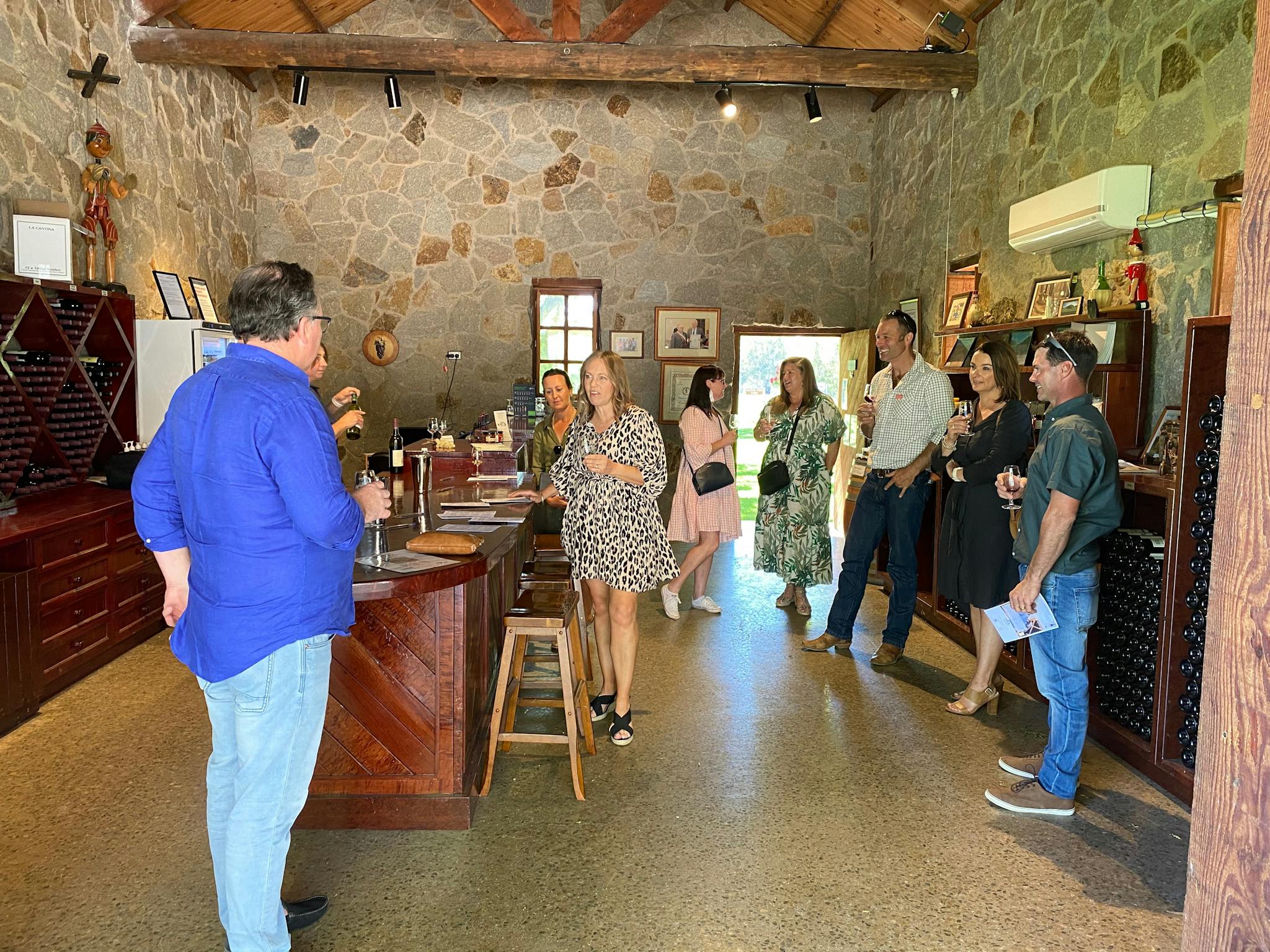 Photo of groups having a wine tasting in a Italian style stone tasting room