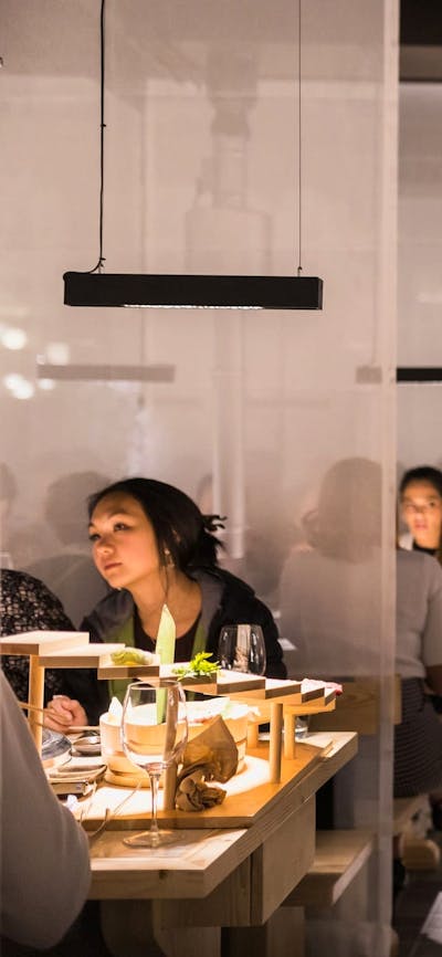 Service staff talking to patrons sitting at tables