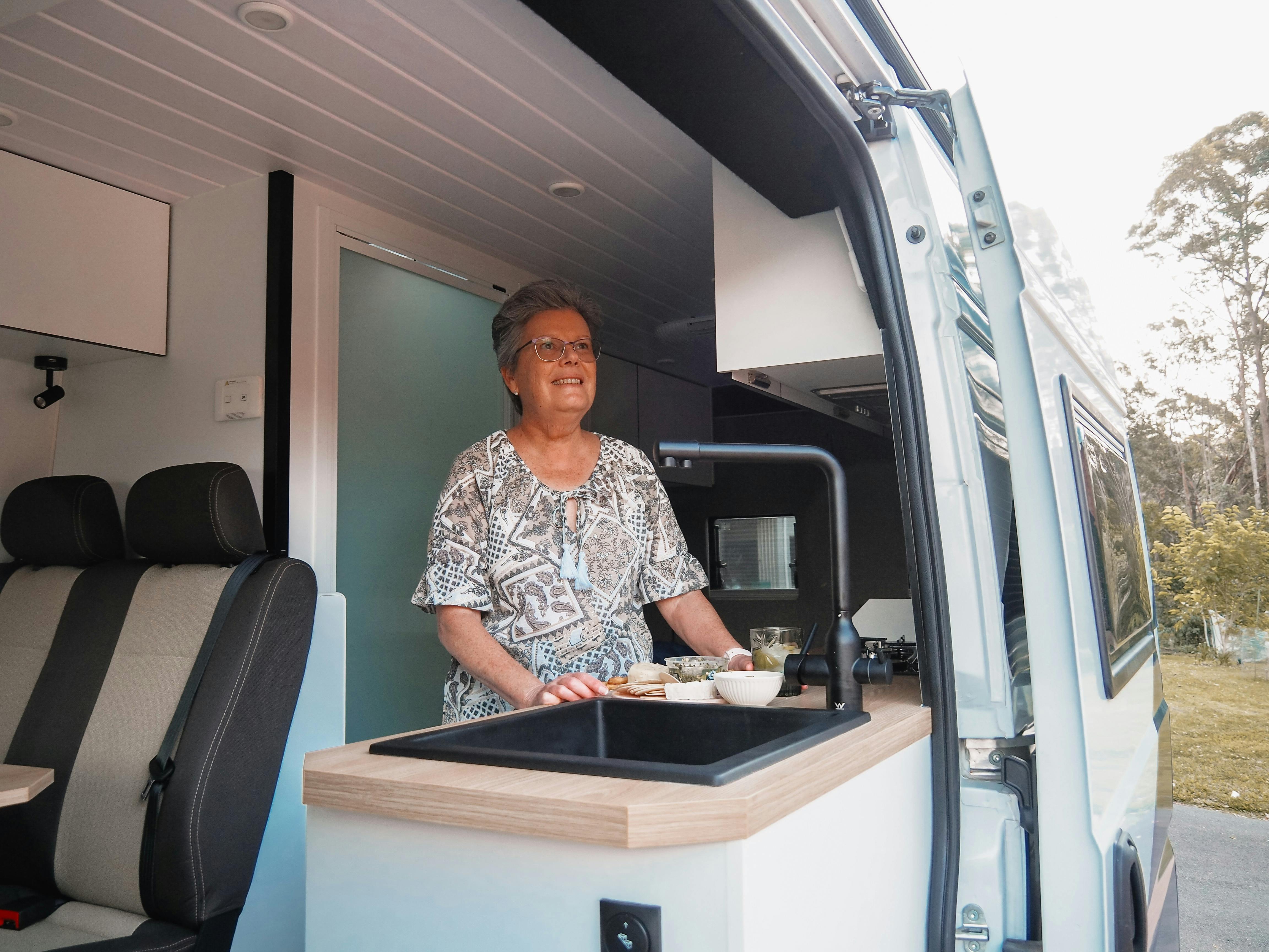 Women looking at the view from the kitchen of Polaris 2 Star RV motorhome
