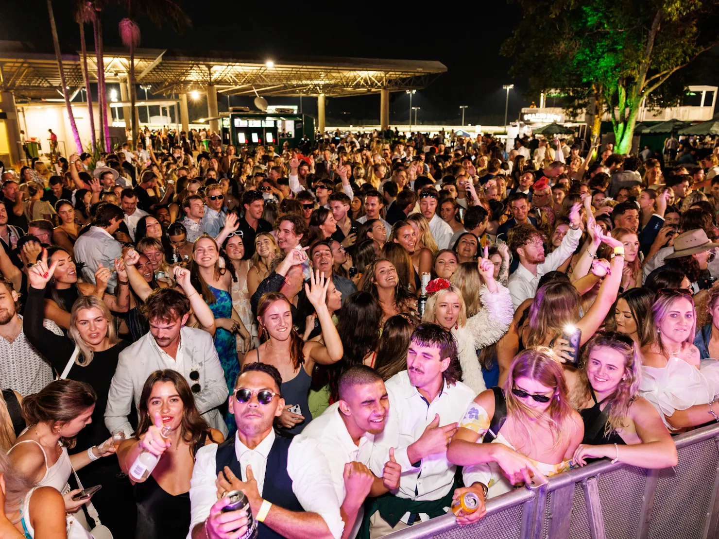 Image of the moshpit crowd from the side of the stage. People dancing.