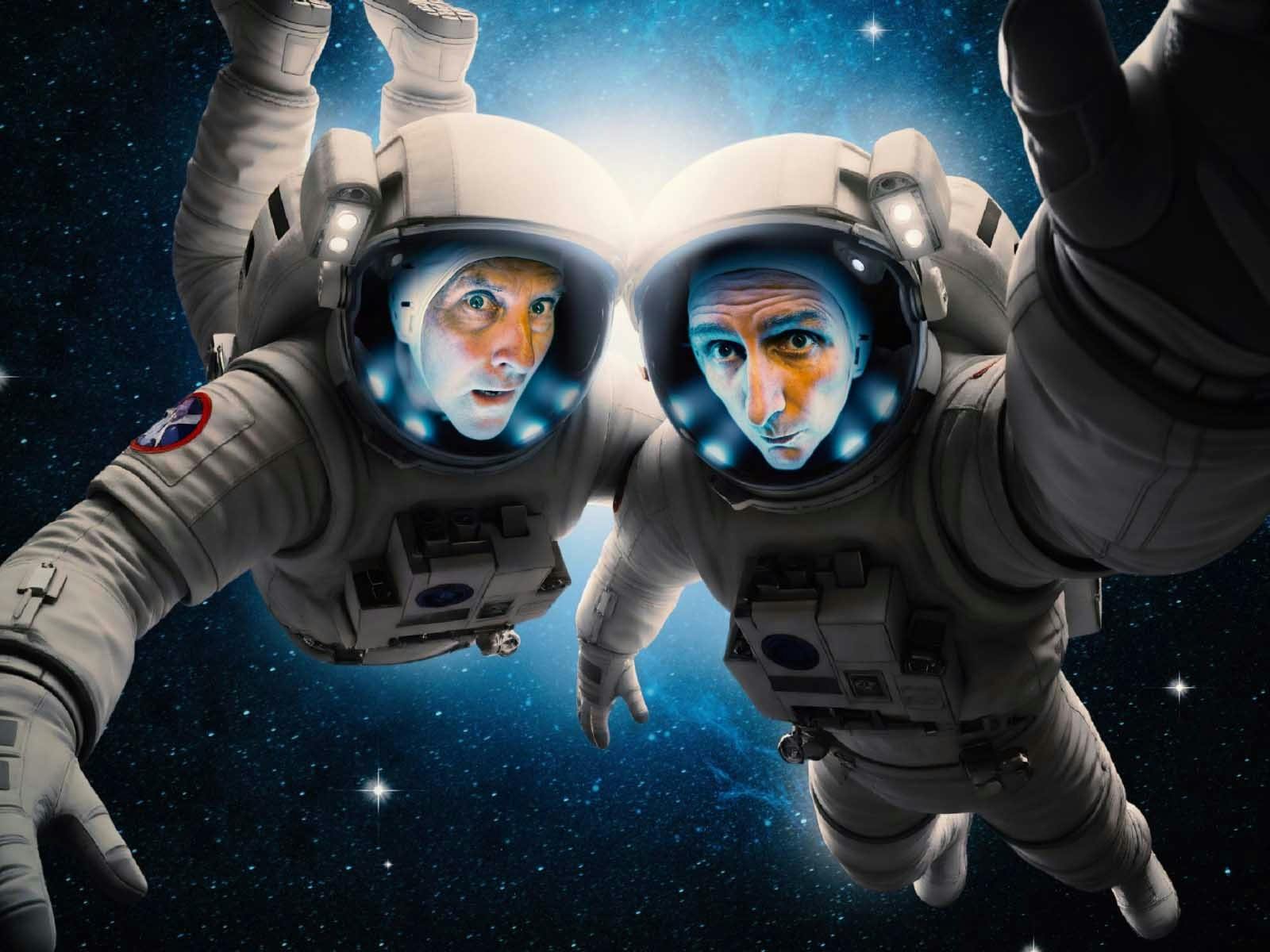 Lano & Woodley in spacesuits floating in space
