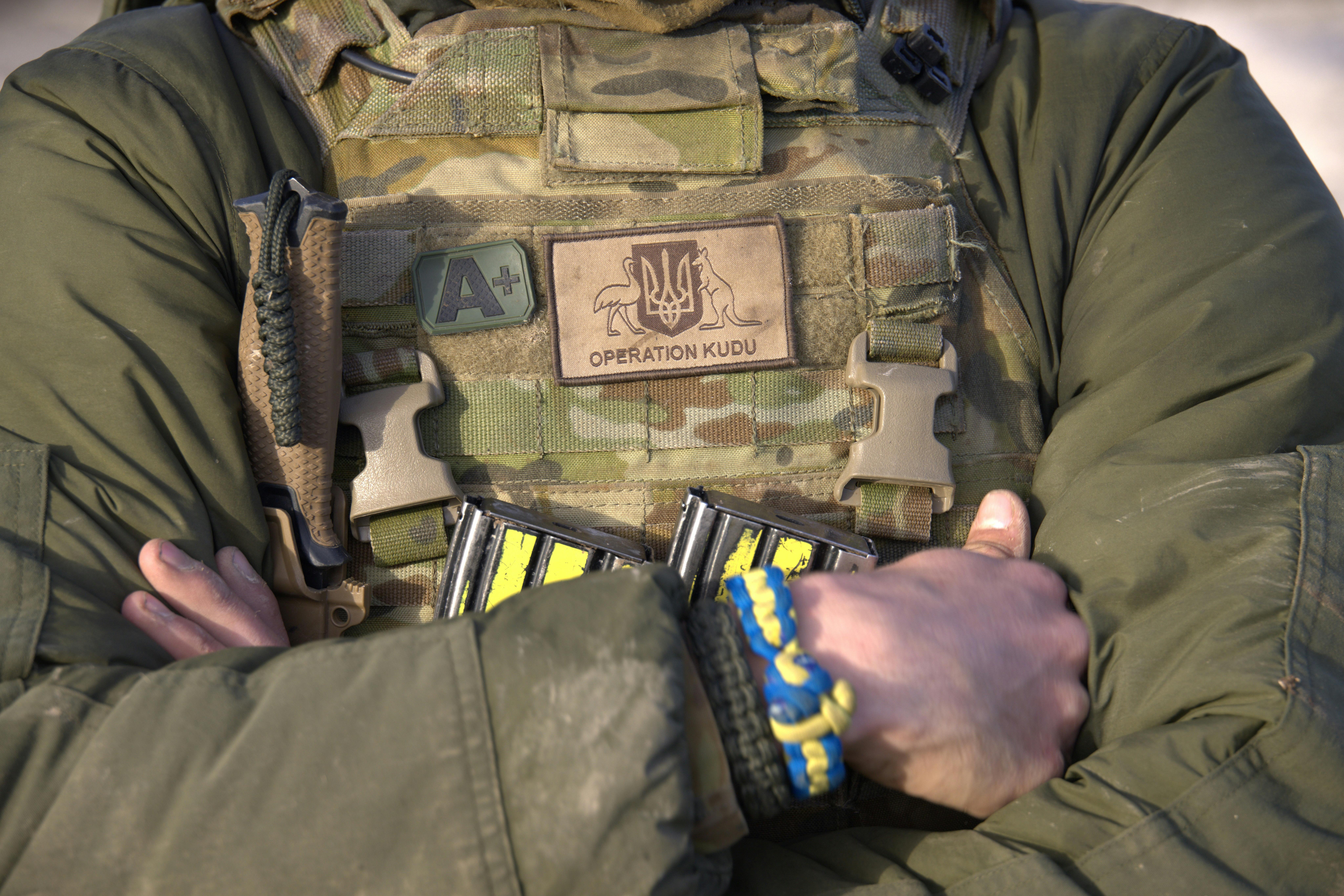 Soldier with operation Kudu patch and blue and yellow friendship braclelet