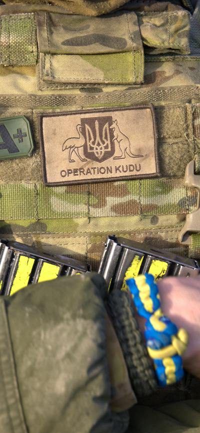 Soldier with operation Kudu patch and blue and yellow friendship braclelet