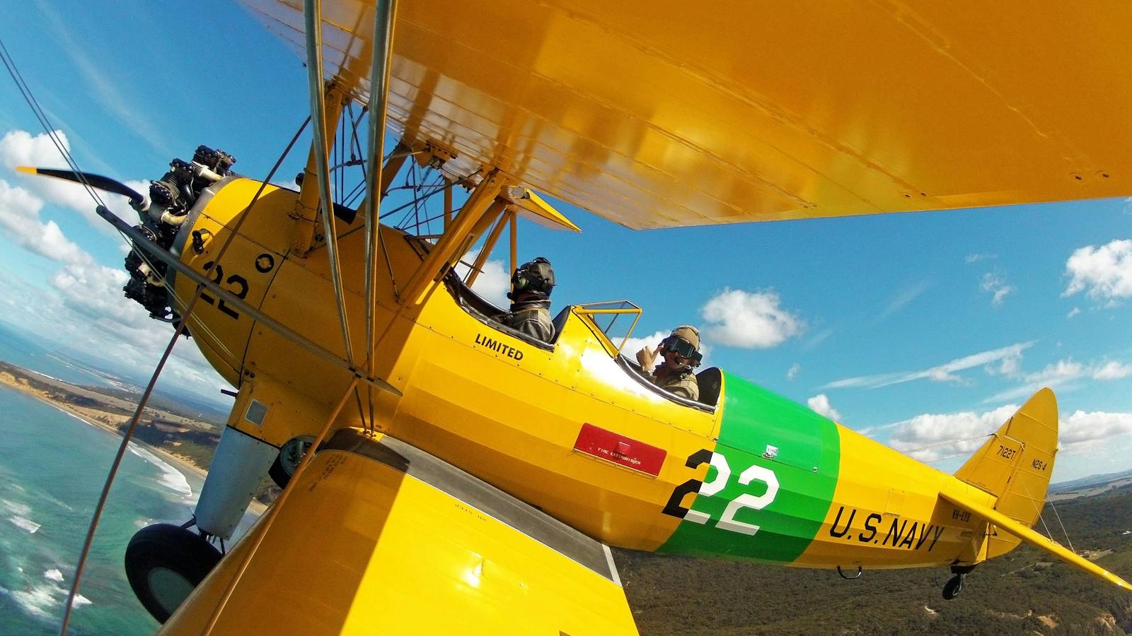 Flying along the coast in a Tiger Moth World WW2 biplane