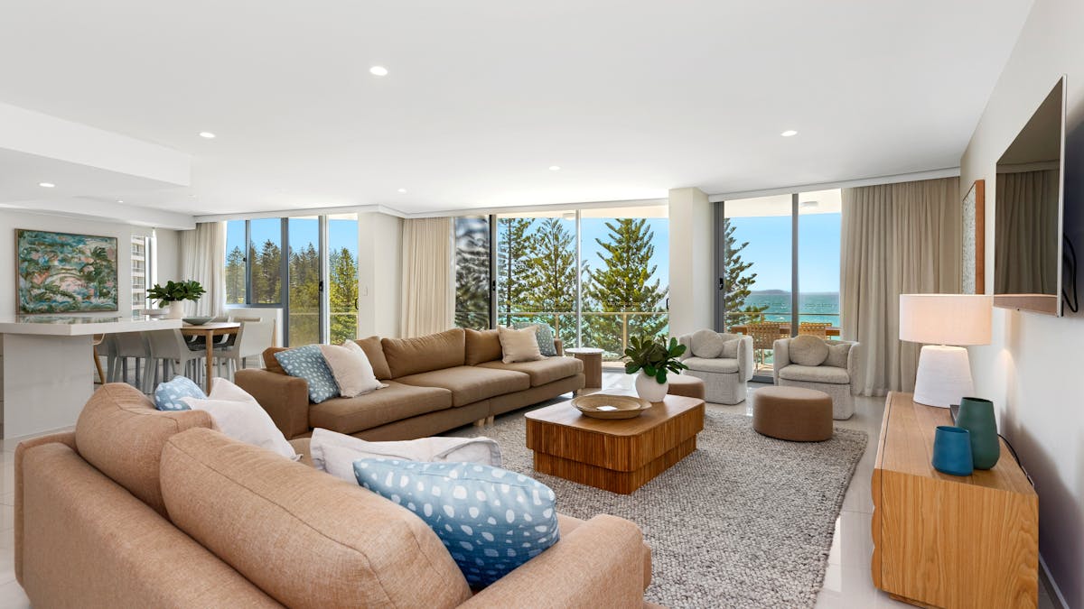 Warm, inviting lounge featuring two large tan lounges, elegant decor, and breathtaking ocean views Warm, inviting lounge featuring two large tan lounges, elegant decor, and breathtaking ocean views
