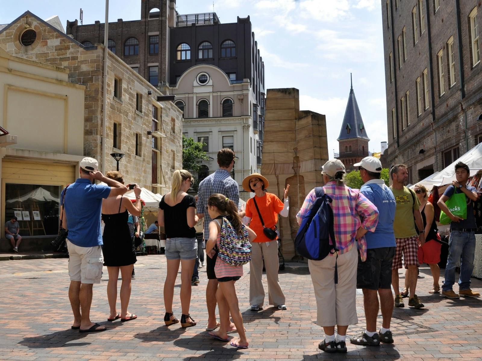 Sydney walking tour is in The Rocks, Sydney. Participants are listening to their guide