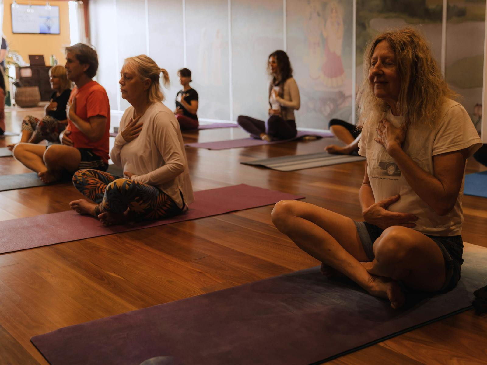Group of people doing yoga breathing