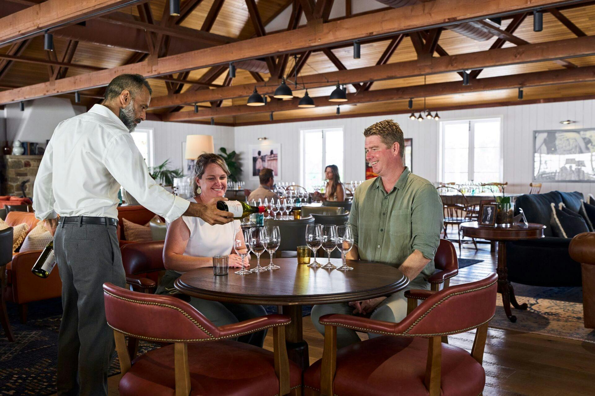 Wine tasting at the cellar door with a guide pouring for guests