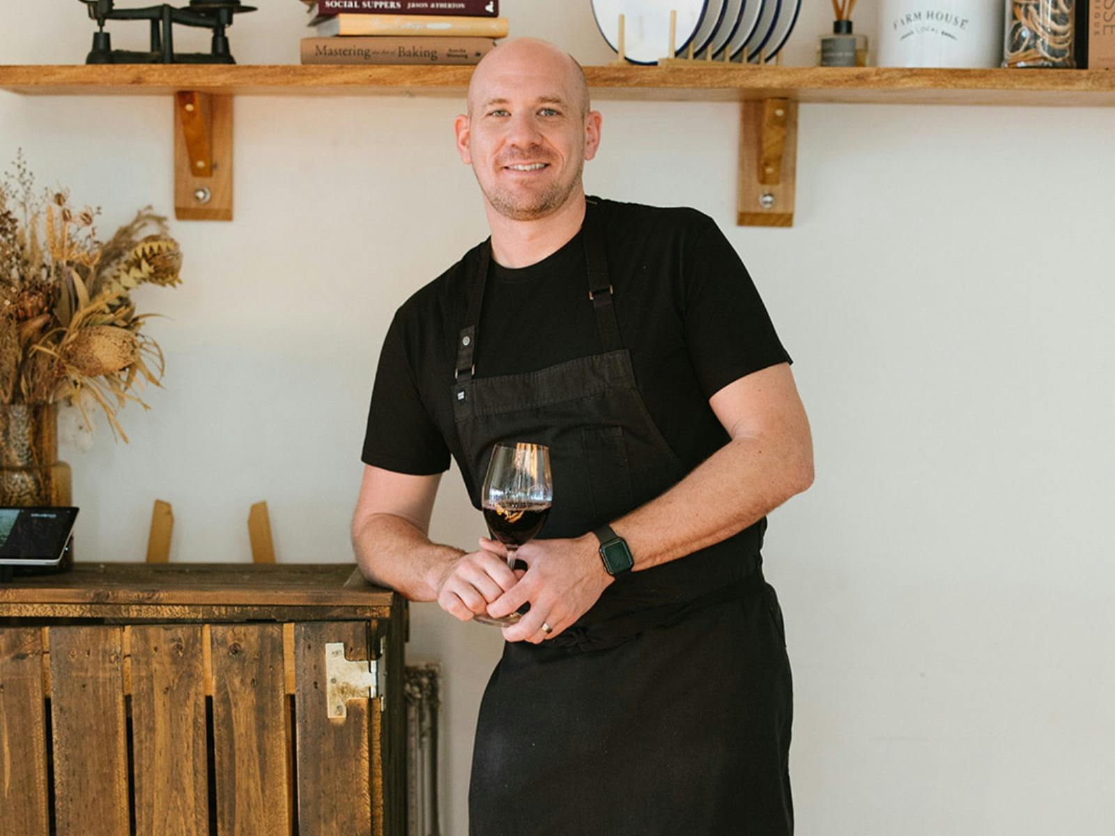 gordon macgregor standing with glass of wine