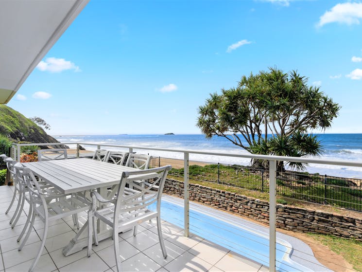 Outdoor dining with views of the pool and ocean