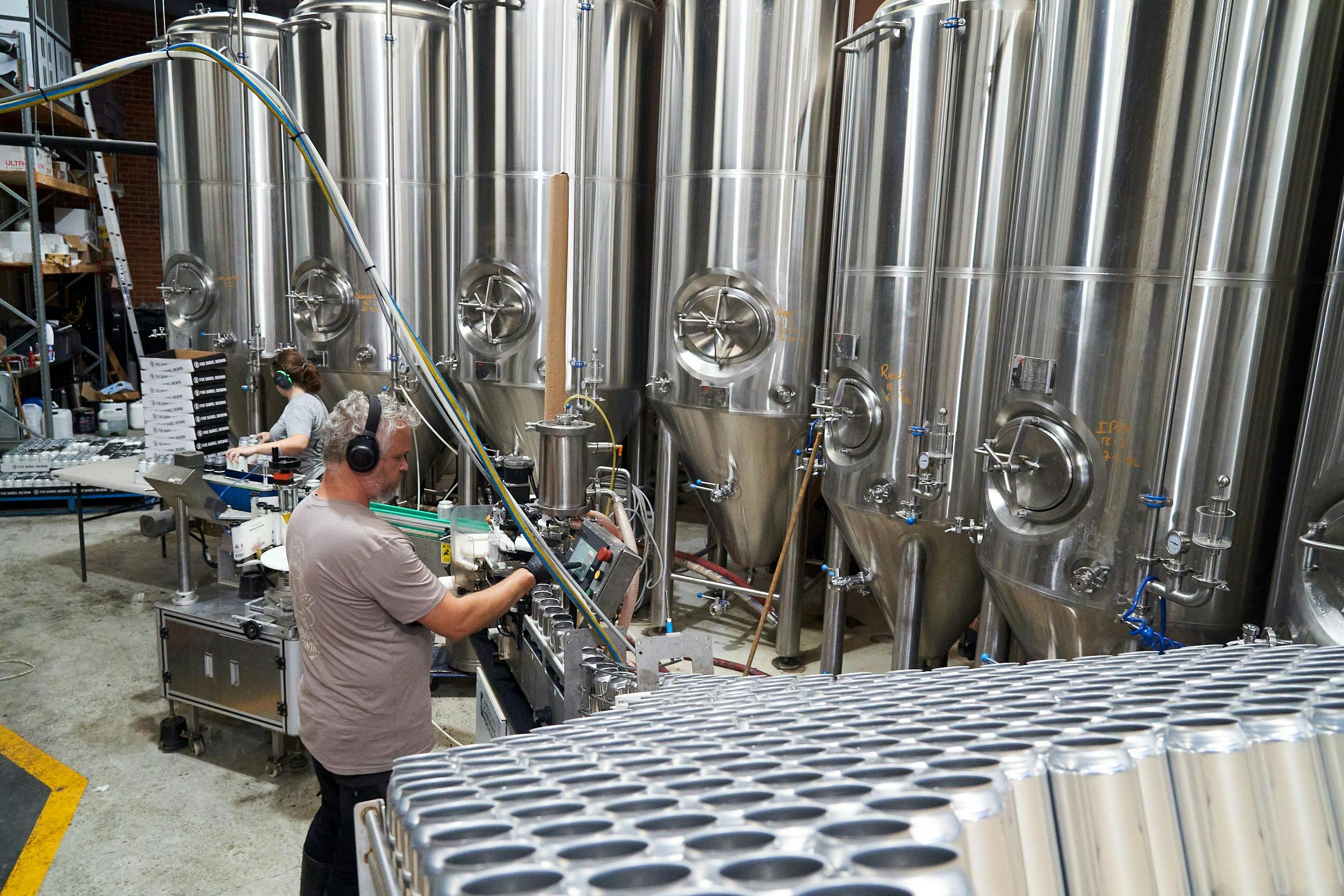 Staff operating the canning machine