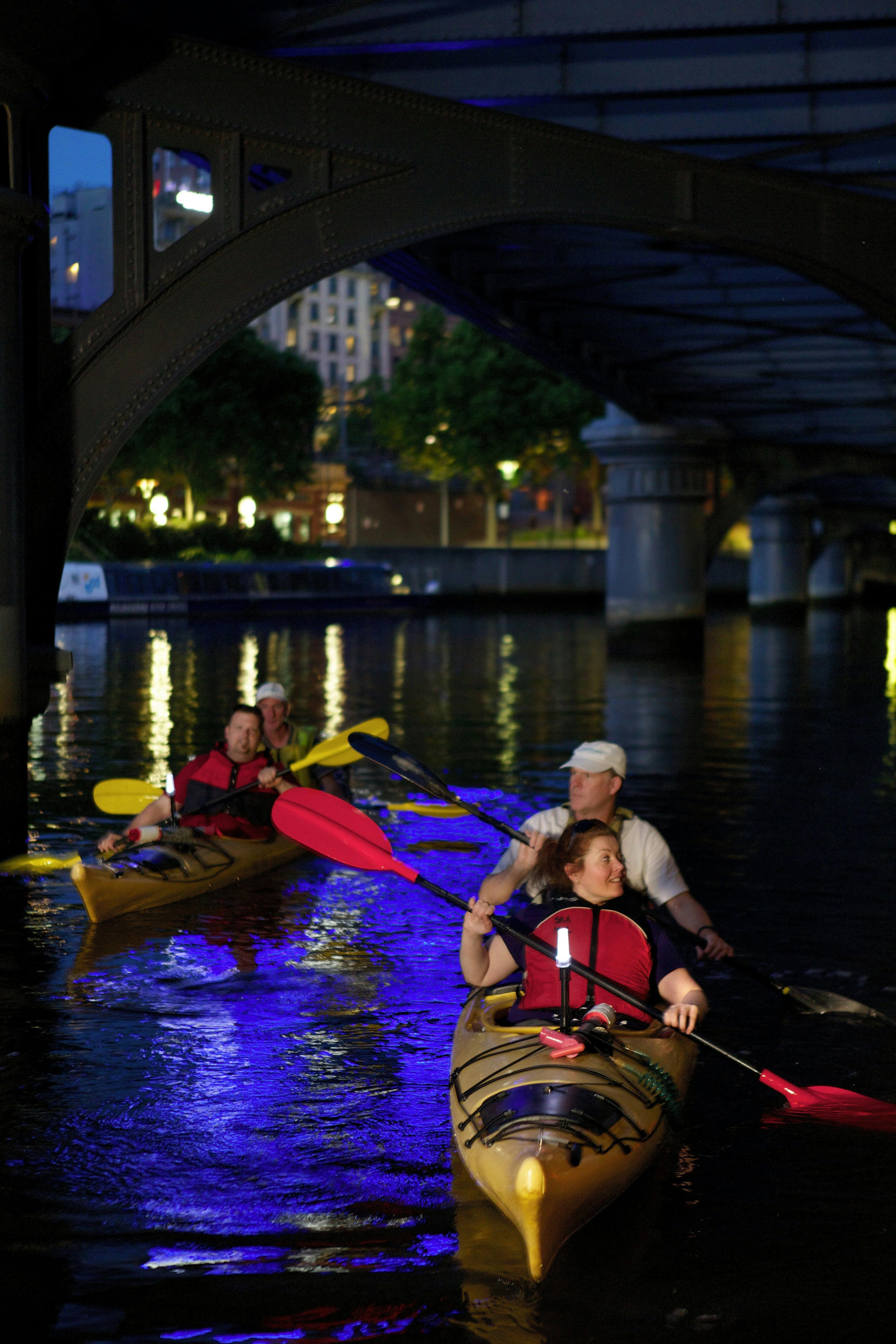 Paddling under a bridge on a Melbourne City Twilight Kayak Tour