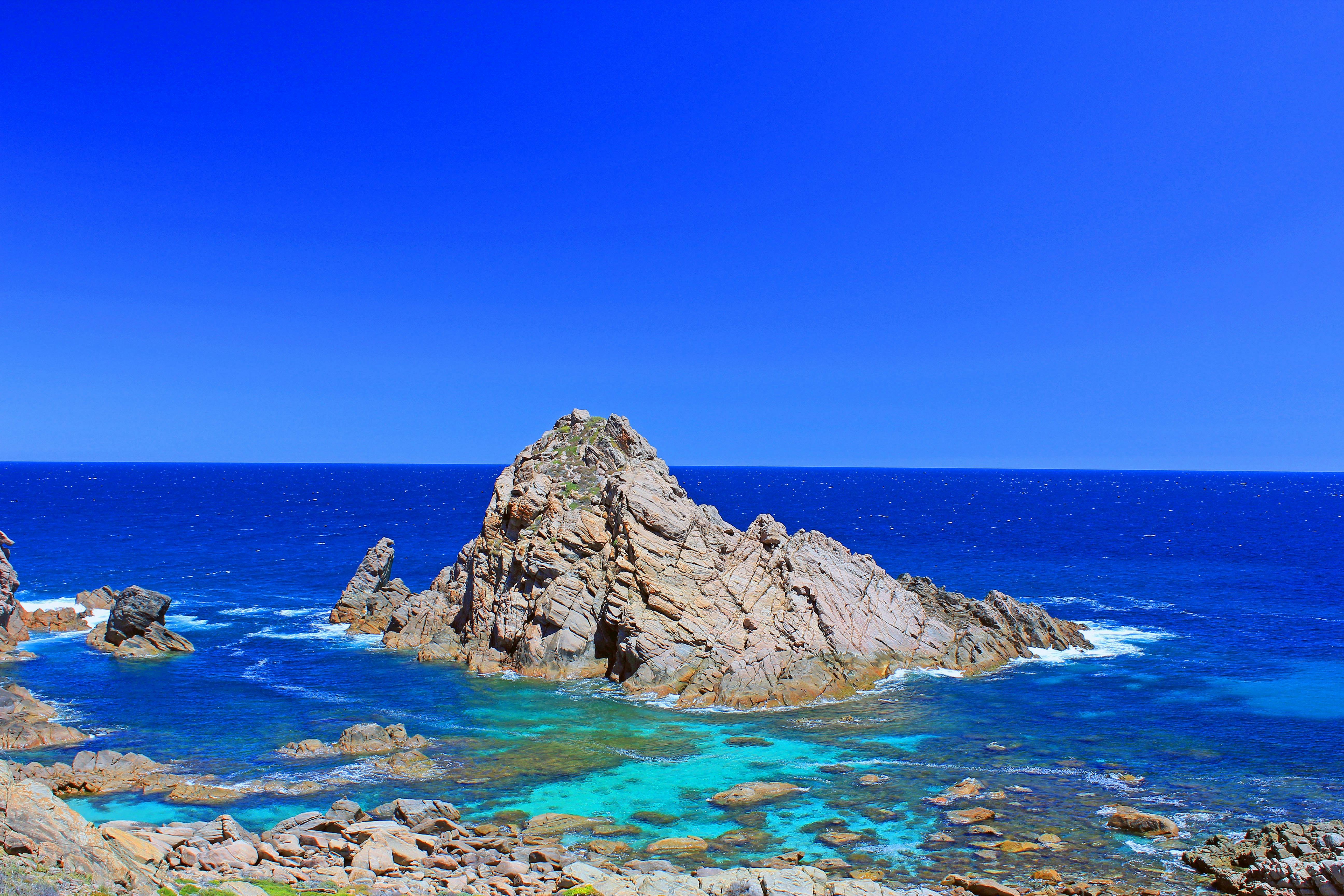 Rocks poking out of the ocean.