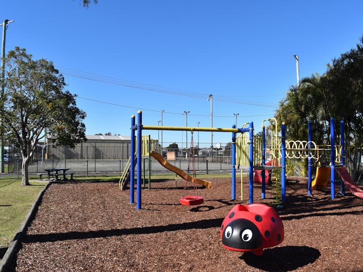 Fenced children's playground, picnic tables, shade and toilets near.  Next to Pool. Partridge St.