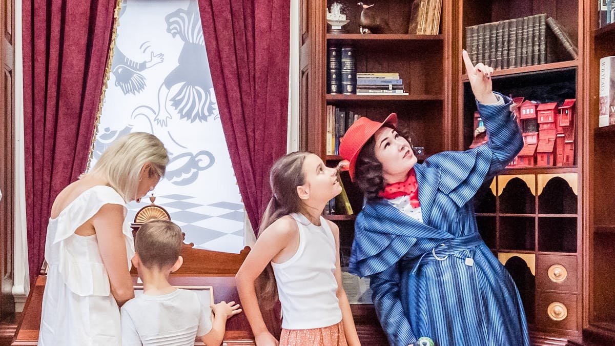 Visitors and interpreter in the library at The Story Bank